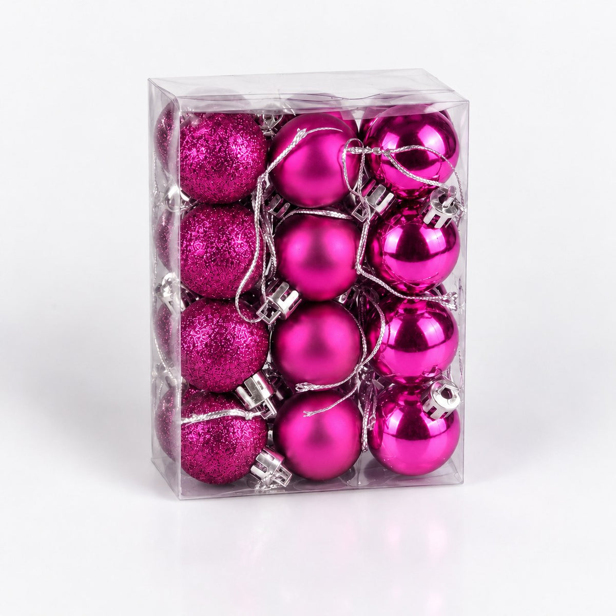 Caja transparente con adornos magenta navideños